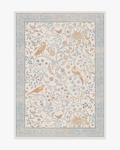 a white and blue rug with birds on it