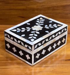 a black and white box sitting on top of a wooden table