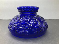 a blue vase sitting on top of a table