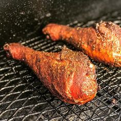 two pieces of meat cooking on a grill