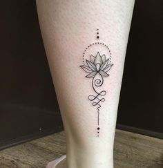 a woman's leg with a tattoo design on the lower part of her leg