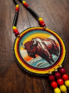 a beaded necklace with an image of a bison on it