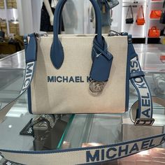 Michael Kors Mirella Small Shopper Top Zip Logo Crossbody Xbody Bag Mk Denim Nwt Authentic Whether You’re Heading To A Daytime Event Or Simply Running Errands, The Mirella Will Meet The Moment. Fit All Your Essentials Into This Charming Mini Tote, Which Can Be Carried By The Top Handles Or Worn Crossbody Thanks To A Woven Shoulder Strap. Crafted From Signature Logo-Print Canvas With Our Iconic Lettering And Charm, It’s A Reliable Way To Spice Up Any Outfit. Crossbody Bag Canvas 89.4% Coated Canv Casual Shopping Bags With Logo Hardware, Designer Canvas Bags With Logo Hardware, Blue Shoulder Bag With Logo Hardware For Travel, Blue Top Handle Shoulder Bag With Logo, Blue Top Handle Bag With Logo, Blue Bags With Logo Hardware, Designer Blue Bags With Logo Hardware, Blue Logo Crossbody Bag, Michael Kors Bag With Adjustable Strap For On-the-go