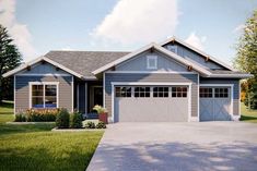 a blue house with two garages in the front yard