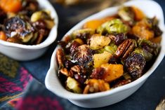 two white bowls filled with fruit and nuts