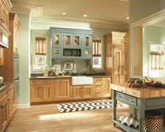 a kitchen filled with lots of wooden cabinets