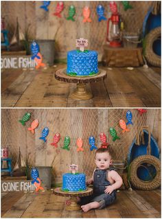 a baby boy sitting on the floor in front of a blue cake with fish decorations