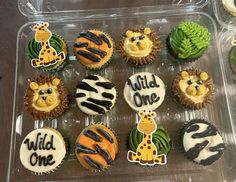 cupcakes decorated with zebra, giraffe and lion faces in plastic containers