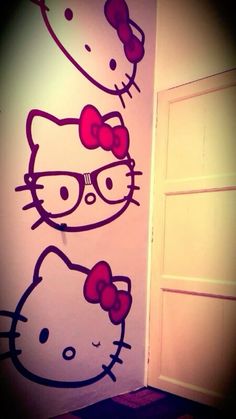 two hello kitty wall decals on the side of a door