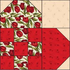 a red and white quilt with flowers on the front, one block in the middle