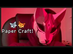 a paper fox mask sitting on top of a leather chair with the words paper craft above it