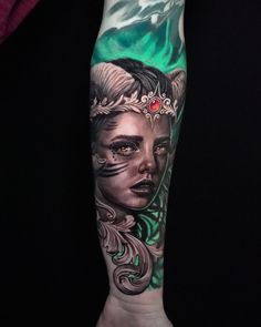 a woman's arm with tattoos on it and an eye in the center is shown