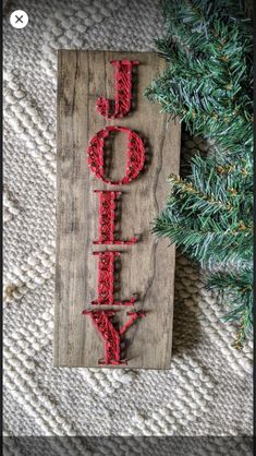 a wooden sign that says joy on it