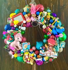 a wreath made out of toys on top of a wooden table