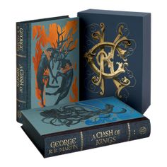 three books with gold and blue covers on them