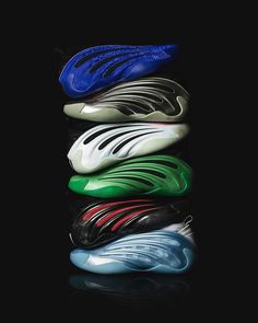 five different colors of soccer cleats sitting on top of each other in front of a black background