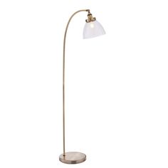 a floor lamp with a white shade on the top and a gold base, against a white background