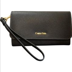 Calvin Klein Saffiano Flap Wristlet In Black New With Tags Genuine Leather Flap Closure Elegant Travel Wallet With Wrist Strap, Modern Wristlet With Wrist Strap, Elegant Wristlet With Adjustable Strap For Travel, Chic Evening Wallet With Wrist Strap, Classic Evening Wristlet, Lululemon Tights, Calvin Klein Handbags, Calvin Klien, Clutch Purse Black