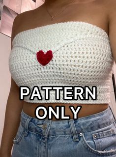 a woman wearing a white knitted top with a red heart on the chest and text that reads, pattern only