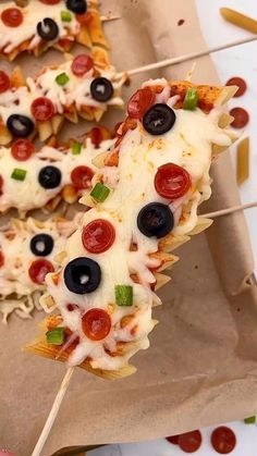 pizza skewers with olives and pepperoni on them