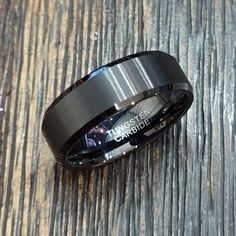 a black ring sitting on top of a wooden table