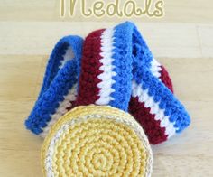 two crocheted baskets sitting on top of a wooden table