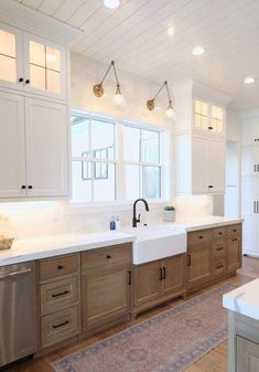 a large kitchen with wooden cabinets and white counter tops, along with a rug on the floor