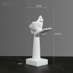 a white sculpture is shown with measurements for it's head and hand holding a tray