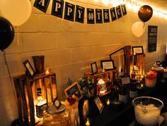 there is a party decoration with balloons and pictures on the wall, candles in front of them