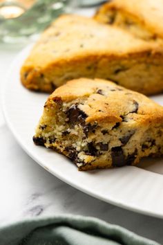 two chocolate chip cookies on a white plate