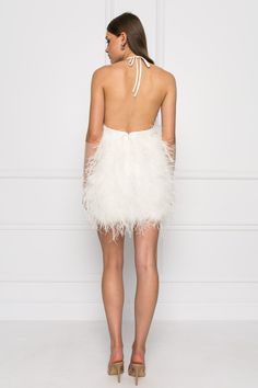 Step out in confidence in the SOLVEIG feather dress. With it’s eye-catching feathers and deep plunge halter neckline, this showstopper will elevate your look at your next event to exquisite new heights. White Halter neck Deep plunge neckline Outer Shell: 100% Ostrich Feathers Lining: 100% Polyester Available for PRE-ORDER. Orders are expected to ship by mid-August. Chic Ostrich Feather Mini Dress For Evening, Cocktail Mini Dress With Ostrich Feathers, Evening Mini Dress With Ostrich Feathers, Chic Ostrich Feather Mini Dress For Party, Spring Party Mini Dress With Ostrich Feathers, Chic Ostrich Feather Dress For Night Out, Glamorous Ostrich Feather Mini Dress For Cocktail, Night Out Dress With Ostrich Feather Trim, White Ostrich Feather Evening Dress