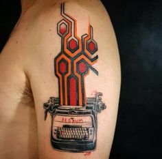 a man's arm with an old fashioned typewriter tattoo on it