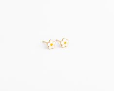 14k Solid Daisy Studs (Ready to ship within 1 - 2 days) These daisy stud earrings are made of solid gold, they are smooth all the way around and sturdy. Earring Details: - Perfect for all ages -6mm -14k solid gold -Tarnish Free White 14k Gold Flower-shaped Earrings, Handmade White 14k Gold Earrings, Nickel-free 14k Gold White Earrings, White 14k Gold Nickel-free Earrings, Nickel-free White 14k Gold Earrings, Dainty 14k Gold White Earrings, 14k Gold White Hypoallergenic Earrings, Baby Earrings Gold, Newborn Earrings