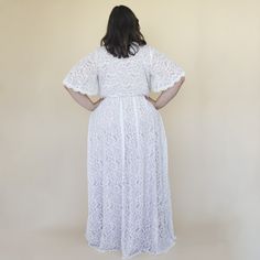 a woman in a white dress is standing back to back with her hands on her hips