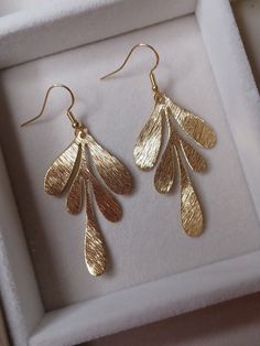 Gold leaf dangle earrings, fishhook ear wire Length is approximately 2 inches brass leaf and gold plated ear wire Leaf-shaped Brass Earrings With Ear Wire, Gold Hypoallergenic Brass Teardrop Earrings, Gold Plated Hypoallergenic Teardrop Earrings, Gold-plated Hypoallergenic Teardrop Earrings, Hypoallergenic Gold Teardrop Brass Earrings, Hypoallergenic Gold Teardrop Earrings In Brass, Gold Dangle Linear Earrings 14k Gold Filled, Minimalist Leaf-shaped Ear Wire Jewelry, Nickel-free 14k Gold-filled Gold Threader Earrings