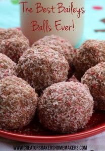 a plate full of chocolate covered balls on a table with a cup in the background