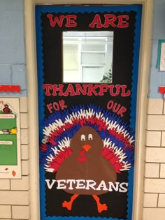 a door decorated with the words, we are grateful for our veterans and a turkey