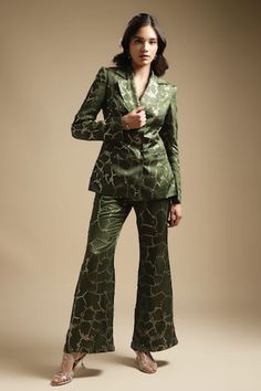 Olive full sleeve double breasted blazer with sequin, bead embroidery. Paired with bell bottom pant.
Components: 2
Pattern: Embroidery
Type Of Work: Sequin, bead
Neckline: Notched lapel collar
Sleeve Type: Full sleeves
Fabric: Satin Linen, Blazer Lining: Satin, Pant Lining: Cotton Mulmul
Color: Green
Other Details: 
Length:
Blazer: 28 inches
Pant: 40 inches
Model height: 5ft 7inches, wearing size M
Occasion: Cocktail - Aza Fashions Silk Long Sleeve Pantsuit, Formal Sequined Long Sleeve Pantsuit, Formal Long Sleeve Sequin Pantsuit, Fitted Sequined Pantsuit With Long Sleeves, Fitted Long Sleeve Sequin Pantsuit, Glamorous Fitted Suits For Workwear, Glamorous Fitted Suits For Work, Designer Suits For Fall Party, Embellished Sets For Workwear