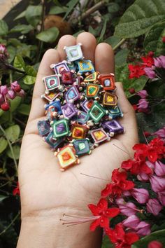 a hand holding a bunch of colorful beads