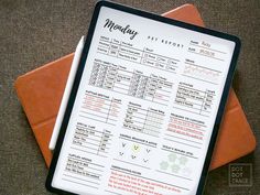 a menu sitting on top of an orange envelope next to a pen and paper with writing