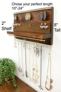 a wall mounted jewelry rack with several pairs of earrings hanging from it's sides