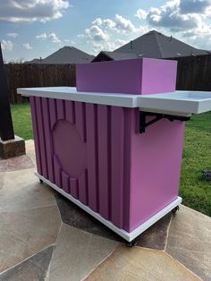 a purple and white container sitting on top of a patio