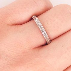 This modern diamond baguette band is a clean, sleek design. With natural baguette diamonds set East to West in bezel settings. This band has a seamless, bright white look! The diamonds are G-H color and VS-1 Clarity, very clear and very white! The bezel settings frame each diamonds perfectly with a bright white 14k white gold. This ring is so beautiful worn alone or can be paired with your engagement ring or right hand ring! It's versatile and looks great with everything. Frame this band between Silver Eternity Band With Baguette Cut Diamonds, Channel Set Baguette Cut Cubic Zirconia Eternity Band, Cubic Zirconia Channel Set Eternity Band In Baguette Cut, Baguette Cut Cubic Zirconia Channel Set Eternity Band, Emerald Cut Cubic Zirconia Eternity Band With Baguette Diamonds, Cubic Zirconia Baguette Cut Channel Set Eternity Band, White Gold Eternity Band With Baguette Cubic Zirconia, Channel Set Baguette Cut Diamond Eternity Band, Diamond White Eternity Band With Baguette Diamonds