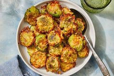 a white plate topped with fried brussel sprouts