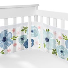 a white crib with blue and pink flowers on it