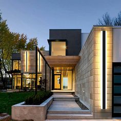 an exterior view of a modern house with steps leading to the front door and entrance