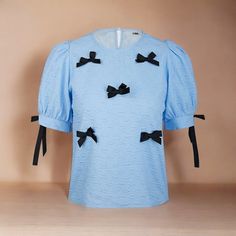 Regular Fit No Stretch Fabric: 70% Polyester 30% Cotton One Size Fits Most Casual Puff Sleeve Tops With Bow, Cotton Puff Sleeve Top With Bow, Chic Blue Tops With Bow, Chic Blue Top With Bow, Sheer Black Shirt, Bow Tie Shirt, White Silk Blouse, Lace Blouse Long Sleeve, Blue Texture