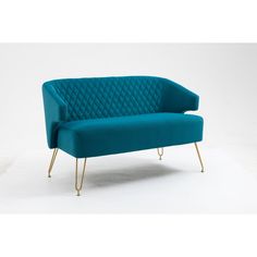 a blue couch sitting on top of a white floor