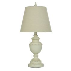 a white lamp with a beige shade on it