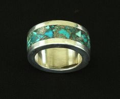 This glamorous Turquoise and Sterling Silver Ring was handcrafted by Nevada Silversmith Jim Daggett. The Ring Band was made from melted Sterling Silver, which was rolled to the desired thickness and then cut, shaped and soldered into a Band. A Sterling Rim was applied at the top and bottom of the Ring, creating a channel in the center. This channel has been inlaid with Turquoise Chip, creating a mosaic of shapes in medium and light-blue hues. The Rolled Sterling is thicker than regular 20 gauge Channel Ring, Bracelets And Rings, Southwest Design, Ring Band, Blue Hues, Turquoise Sterling Silver, Ring Bracelet, Nevada, Semiprecious Stones